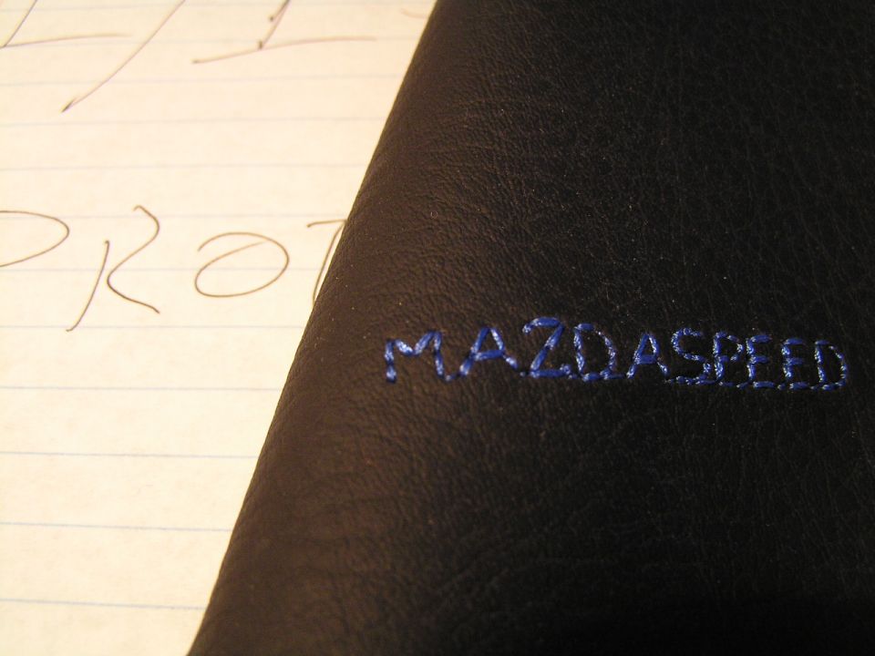 Black leather with 'MAZDASPEED' blue embroidered stitching