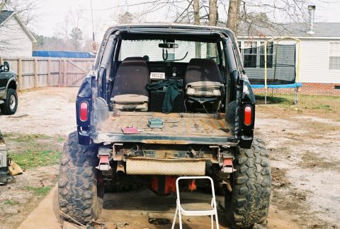1978 Ford Bronco - Rear view of a lifted 1978 Ford Bronco with custom modifications and large off-road tires.