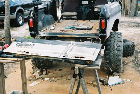 1978 Ford Bronco - Tailgate removed for repair on a 1978 Ford Bronco, with another Bronco in the background.
