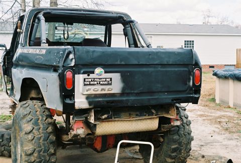 1978 Ford Bronco - This lifted Ford truck features oversized tires and a humorous bumper sticker.