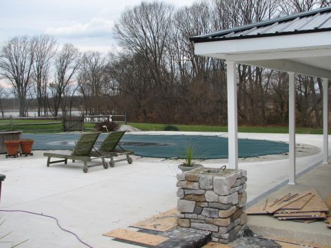 1992 Ford Bronco - A covered pool and patio area are shown on an overcast day, with lounge chairs and landscaping elements visible.
