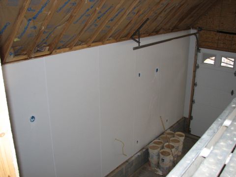 1992 Ford Bronco - Garage interior with unfinished walls, insulation, and a closed garage door visible.