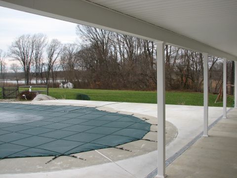 1992 Ford Bronco - A covered porch overlooks a swimming pool and a tranquil lake scene with bare trees.