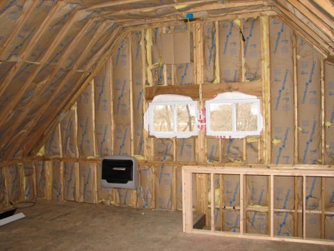1992 Ford Bronco - The interior of an attic space shows unfinished construction with insulation and framing visible.