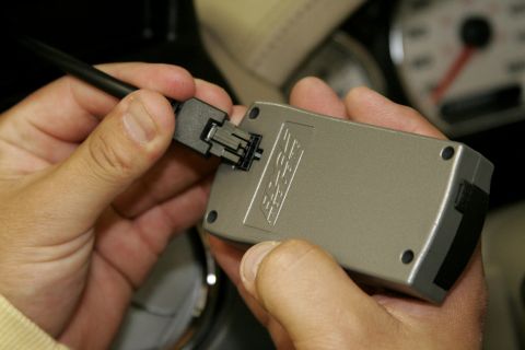 2005 Ford F-150 - With the key off, plug the cable into the OBD2 port and the back of the Evolution programmer, then use the zip ties to fasten the remaining…