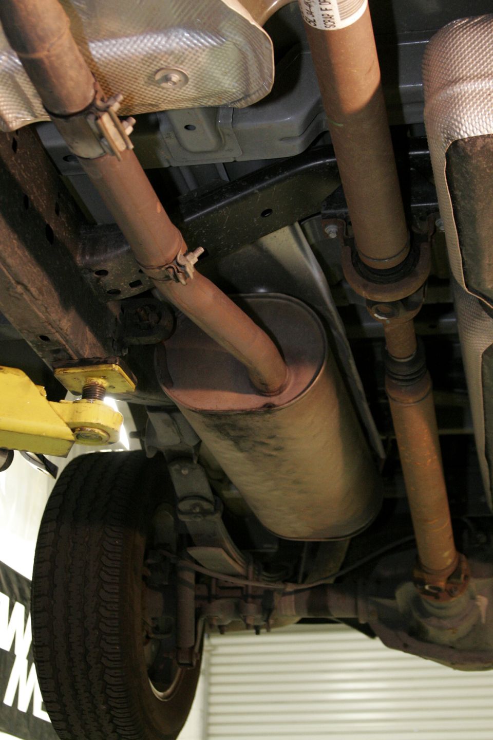 Of course this job is easier with the truck on the lift but this is something you could do simply in your driveway. Begin by loosening the double bolt clamp in front of the muffler.