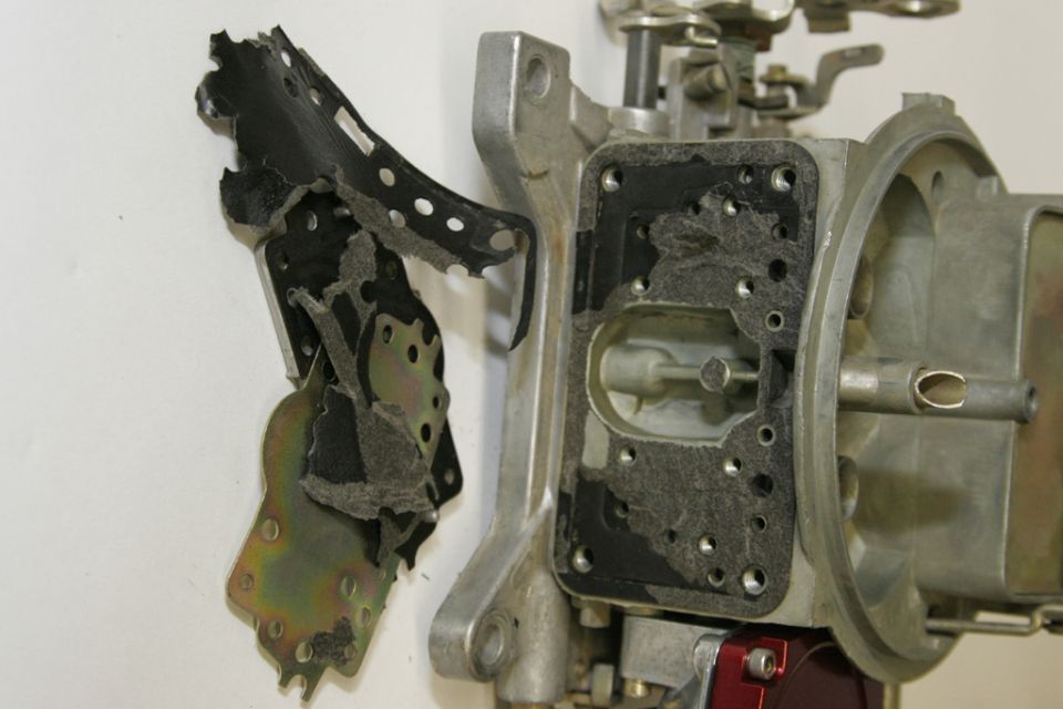 With the plates off, the gaskets will need to be removed.  The new QFT gaskets are coated with florocarbon to prevent sticking, so once installed they make future carb work such simpler and faster.
