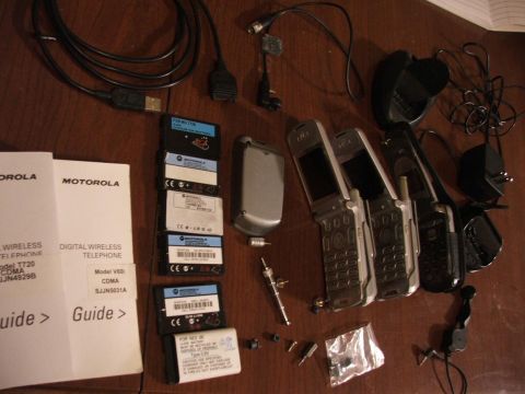 1985 Ford Crown Victoria LTD - Collection of Motorola cell phones, batteries, chargers, and user guides.