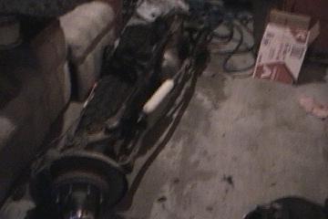 1991 Ford Bronco - Dana 60 axle assembly, likely for a truck or SUV, with brake components and a shock absorber.