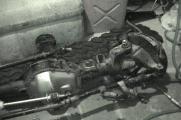 1991 Ford Bronco - Close-up of a Dana 60 axle assembly, likely for a truck or SUV, with suspension parts visible.