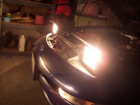 1995 Ford Probe - The pop-up headlights of a blue 1995 Ford Probe are illuminated in this front-view shot.