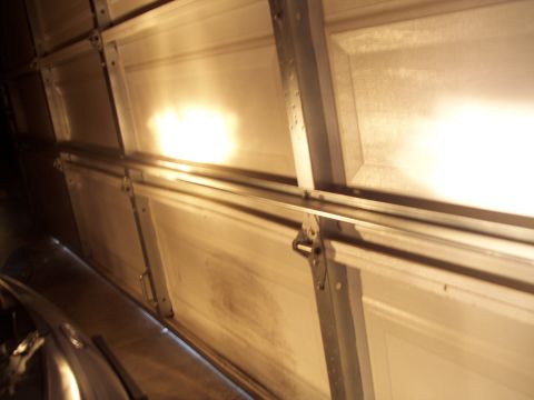 1995 Ford Probe - Interior view of a closed garage door with light reflecting off the panels.