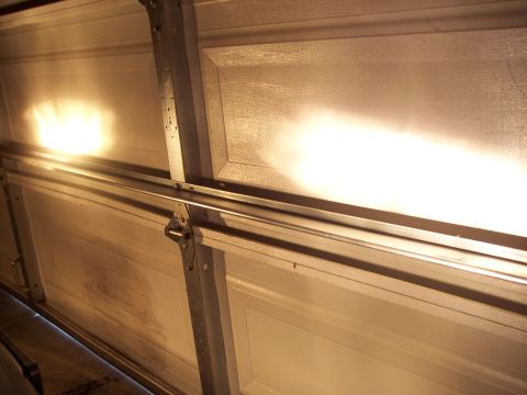 1995 Ford Probe - The image shows a garage door with its lights on, illuminating the interior panels and tracks.