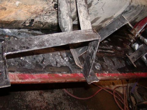 1979 Ford F-150 - Close-up view of the undercarriage, showing structural components and some red painted elements.