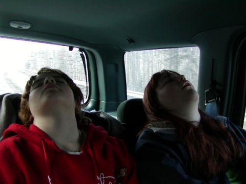 1979 Ford F-150 - Two passengers are asleep in the back seat of a vehicle, heads tilted back.
