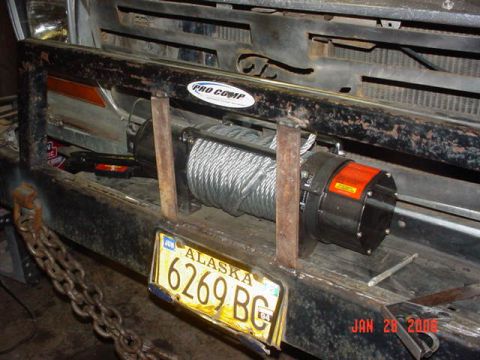 1979 Ford F-150 - A winch is mounted to the front bumper of a truck, with an Alaska license plate attached.