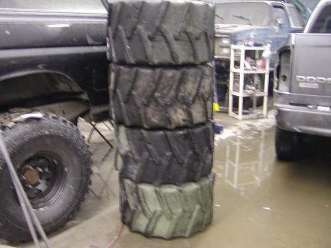 1979 Ford F-150 - A stack of tires sits in a garage, obscuring the view of other vehicles.