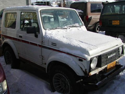 1979 Ford F-150 - A white Suzuki Samurai is parked in the snow, with other vehicles visible in the background.