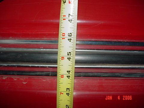 1979 Ford F-150 - A measuring tape is placed on a red vehicle's body panel, with a date stamp of Jan 4 2006 visible.