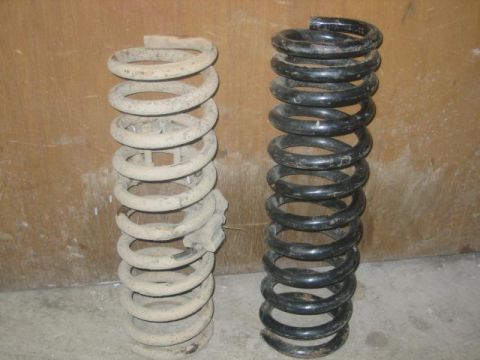 1979 Ford F-150 - Comparison of two suspension coil springs, one showing significant wear and rust.