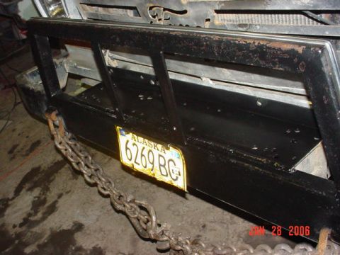 1979 Ford F-150 - A close-up view of a truck's rear bumper, heavy-duty chains and an Alaska license plate.