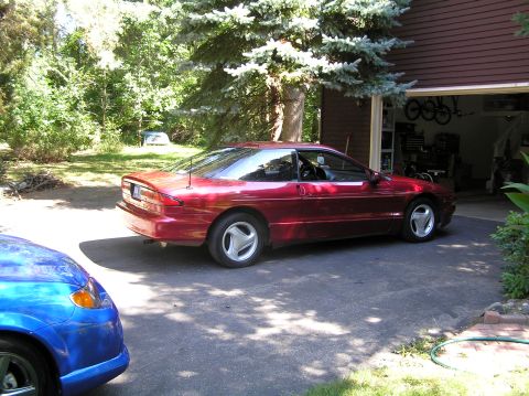 1993 Ford Probe - Red 1993 Ford Probe parked in a driveway with a blue car in the foreground.