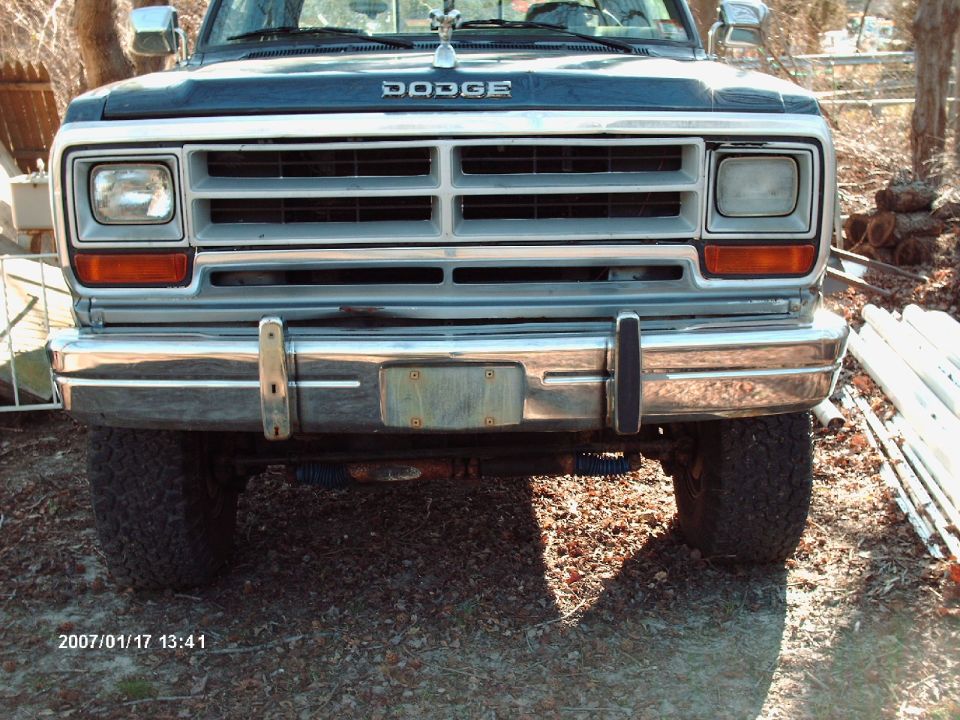 Dodge truck front end with chrome bumper and grille. Date stamp visible