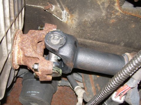 1988 Ford Bronco - This photo shows a close-up view of a vehicle's driveshaft universal joint, highlighting its connection point and surrounding components.