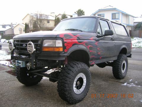 1996 Ford Bronco - This lifted 1996 Ford Bronco features flame decals and auxiliary Hella lights on its custom bumper.