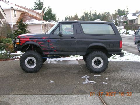 1996 Ford Bronco - Modified 1996 Ford Bronco with custom flame decals and lifted suspension.