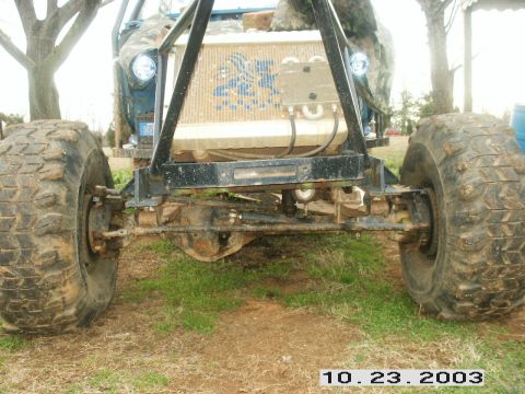 1992 Ford Mustang - An off-road vehicle is shown from the front, with its large tires and exposed mechanical components visible.
