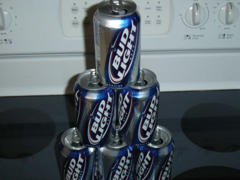 1988 Ford Bronco - A pyramid of Bud Light cans is stacked on a kitchen stove.