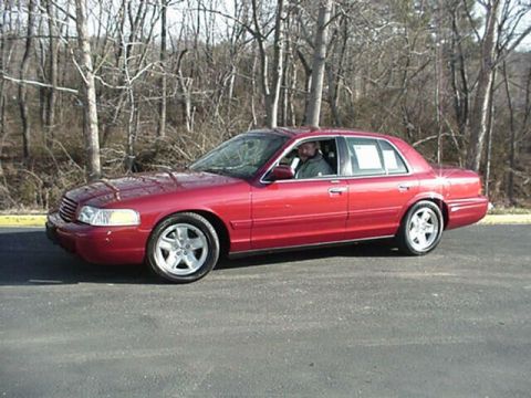 2002 Ford Crown Victoria - This red 2002 Ford Crown Victoria is shown from the front three-quarter view.