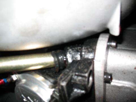 1985 Ford Crown Victoria LTD - Greasy automotive part, possibly from a linkage system, with visible mounting hardware.