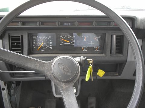 1999 Ford F-800 - Interior view of a Ford truck's dashboard, showing the steering wheel and instrument cluster.