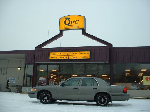 2000 Ford Crown Victoria - A 2000 Ford Crown Victoria sits in the snow in front of a QFC grocery store.
