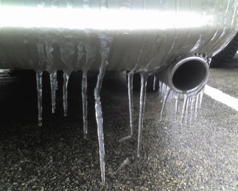2000 Ford Crown Victoria - Icicles hang from a car's exhaust pipe in freezing weather.
