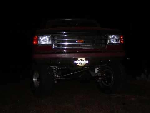 1991 Ford Bronco - Front view of a 1991 Ford Bronco, modified with custom suspension and lighting.