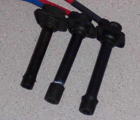1994 Ford Probe - Close-up of three spark plug wires, each with a black boot and colored insulation visible.