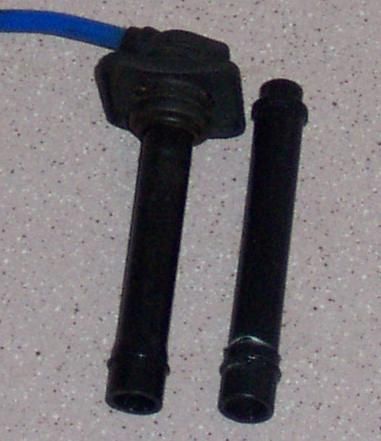 1994 Ford Probe - Close-up of two spark plug wires, one with blue insulation, against a speckled background.