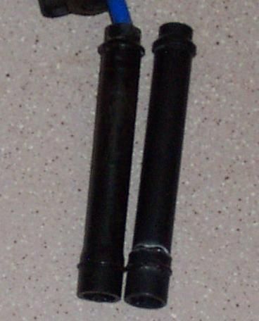 1994 Ford Probe - Two black spark plug wires are shown, one with a blue connector attached.