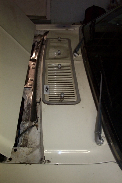 1968 Ford Mustang - A close-up view of a car's hood vent, showing its louvered design and chrome fasteners.