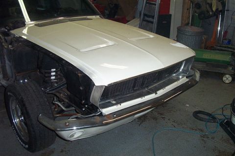 1968 Ford Mustang - Front view of a 1968 Ford Mustang undergoing restoration work in a garage.