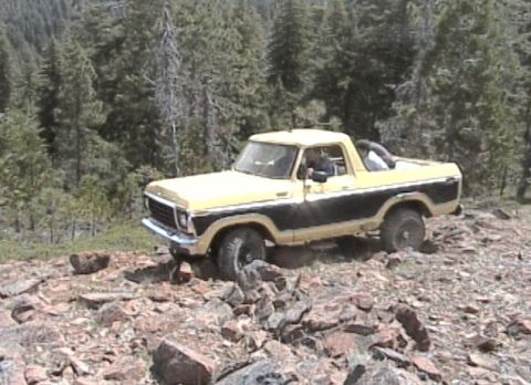 1979 Ford Bronco - This 1978 Ford Bronco is navigating a rocky trail with a wooded background.