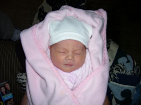 1987 Toyota 4Runner - A newborn baby sleeps peacefully, swaddled in a soft pink blanket.