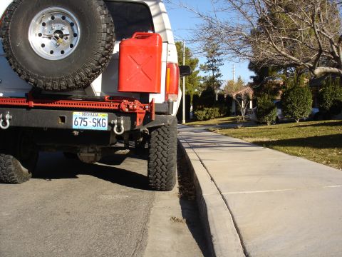 1996 Ford Bronco - Rear view of a 1996 Ford Bronco equipped with a spare tire, Hi-Lift jack, and a jerry can.