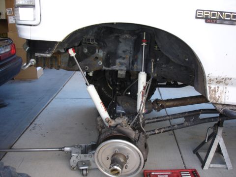 1996 Ford Bronco - The front suspension of a 1996 Ford Bronco XLT is shown with the wheel removed for service.