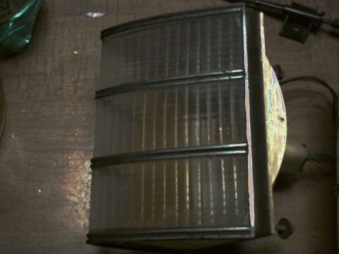 1973 Ford Ranchero - This is a clear tail light assembly with horizontal ribs and chrome trim, likely a replacement part.