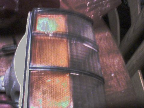 1973 Ford Ranchero - Close-up of a car tail light assembly, showing amber and clear lens sections.