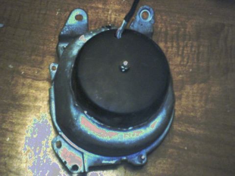 1973 Ford Ranchero - This image shows a black automotive part with a mounting bracket and a wire, likely a component from a vehicle's electrical or mechanical s…